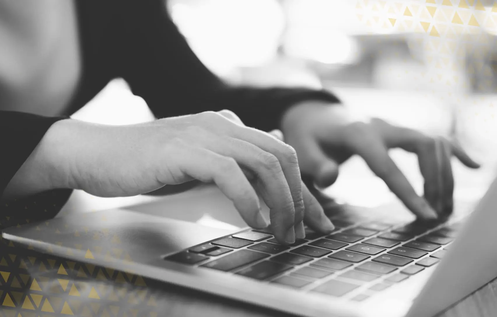 hands typing on laptop