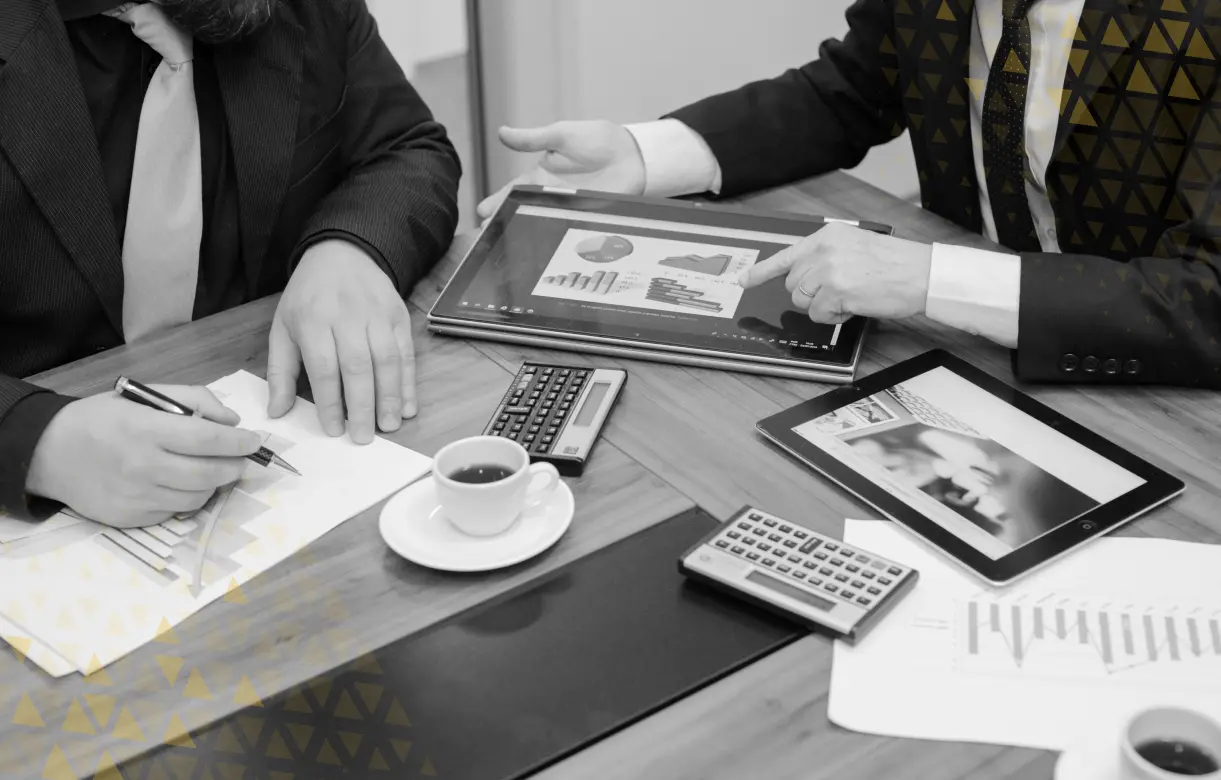 business people's hands over tablets and calculators