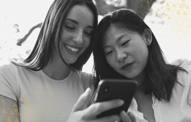 Two woman looking a cell phone