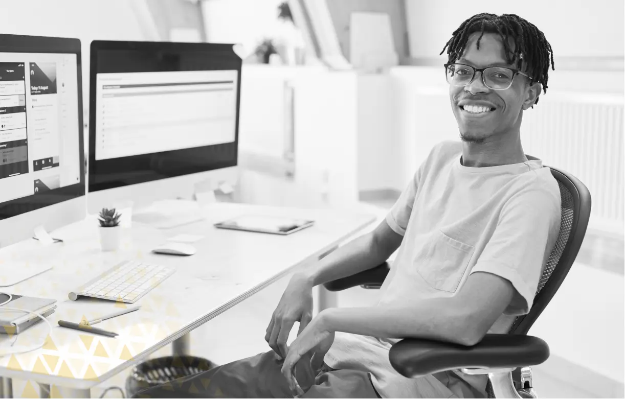 guy smiling next to a computer