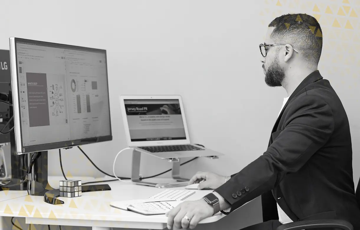 Businessman working on two monitors