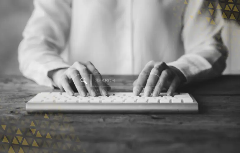 close up of two hands typing on a keyboard